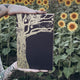 Lips Touch by Laini Taylor Illumicrate edition in a field of sunflowers
